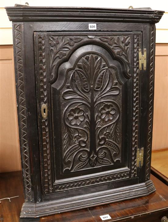 A mid 18th century ebonised oak hanging corner cupboard, W.66cm H.85cm
